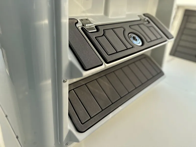 Slide: The Image of 2025 Pathfinder 2400 Open boat storage compartment with sleek black paneling. - 21