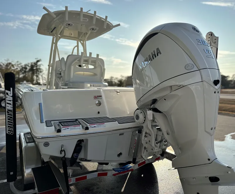 Slide: The Image of 2025 Pathfinder 2400 Open boat with Yamaha engine, parked on a trailer, sunny day. - 6
