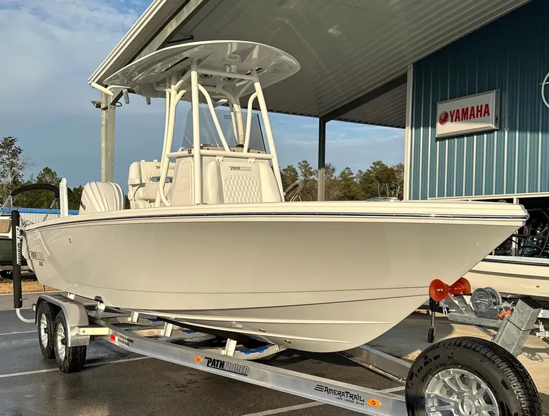 Slide: The Image of 2025 Pathfinder 2400 Open boat on trailer at dealership, Yamaha sign visible. - 8