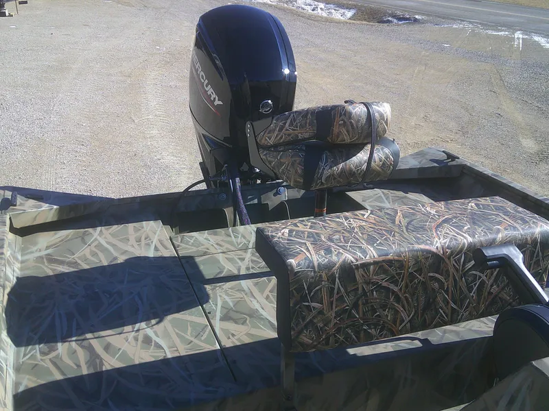 Slide: The Image of 2025 Lund 2070 Predator CC boat with camouflage seating and Mercury outboard motor. - 10