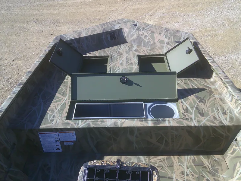 Slide: The Image of 2025 Lund 2070 Predator CC boat with open storage compartments and camouflage design. - 4