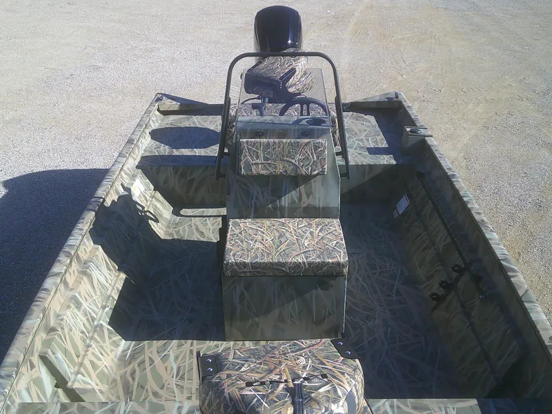 Slide: The Image of 2025 Lund 2070 Predator CC boat with camouflage interior, center console, and steering wheel. - 5