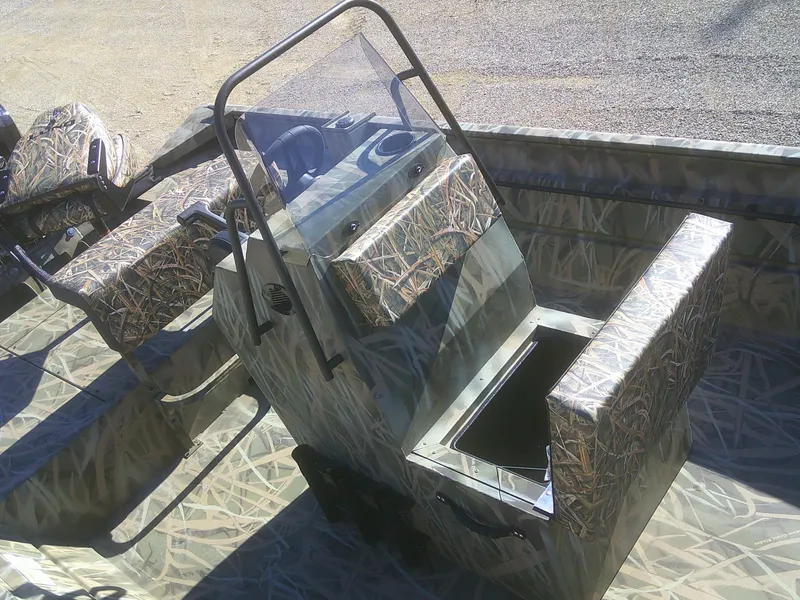 Slide: The Image of 2025 Lund 2070 Predator CC boat interior with camouflage seating and console. - 6