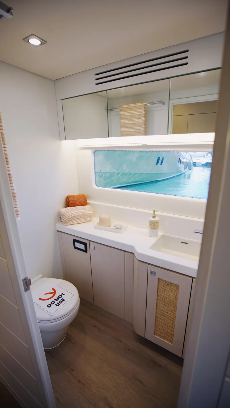 Slide: The Image of Modern yacht kitchen interior with ocean view, featuring sleek countertops and decorative plants. - 13