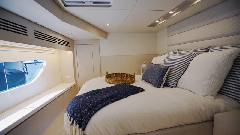 Slide: The Image of Luxurious yacht interior with modern kitchen, featuring sleek cabinets and ocean views. Two Oceans 555 - 008, 2025. - 15