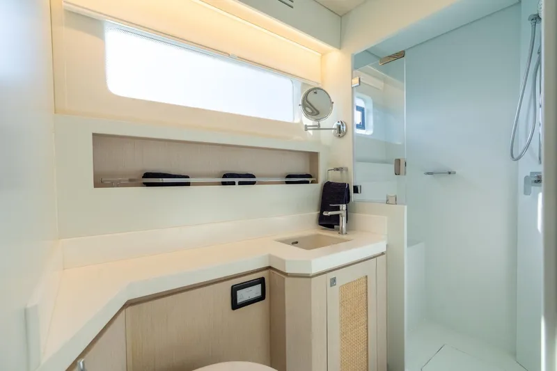 Slide: The Image of Modern yacht bathroom with sleek design, featuring a shower and vanity. Two Oceans 555 - 008, 2025 model. - 27