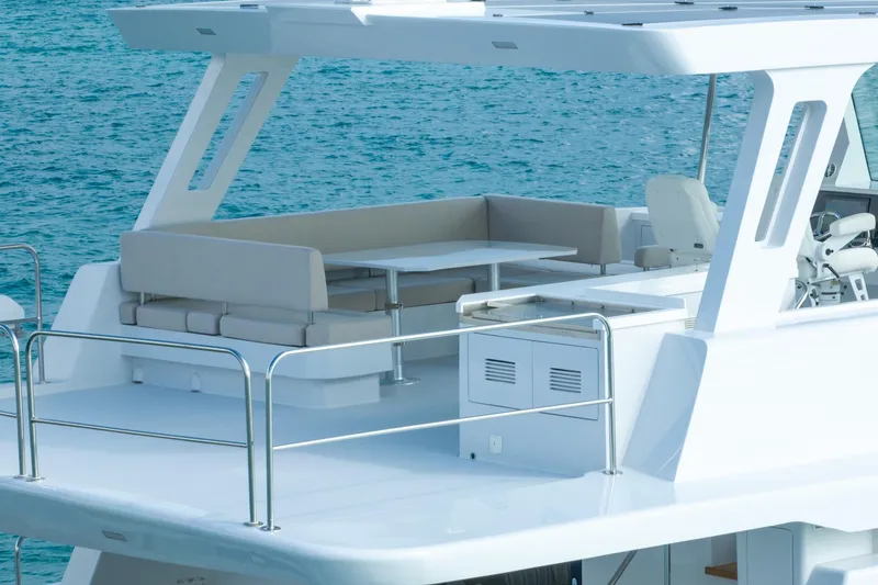 Slide: The Image of Luxurious Two Oceans 555 - 008 yacht deck with seating, 2025 model, on serene blue water. - 41
