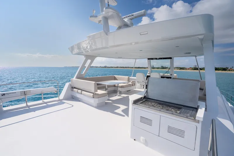 Slide: The Image of Luxurious 2025 Two Oceans 555-008 yacht deck with seating and grill, overlooking serene ocean. - 43