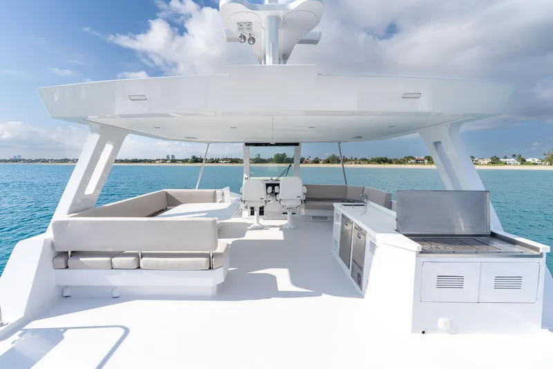 Slide: The Image of Luxurious 2025 Two Oceans 555-008 yacht deck with seating and grill, overlooking serene ocean. - 44