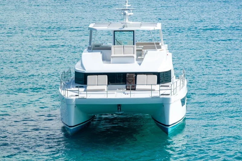 Slide: The Image of Luxury catamaran "Two Oceans 555 - 008" on clear blue water, 2025 model. - 56