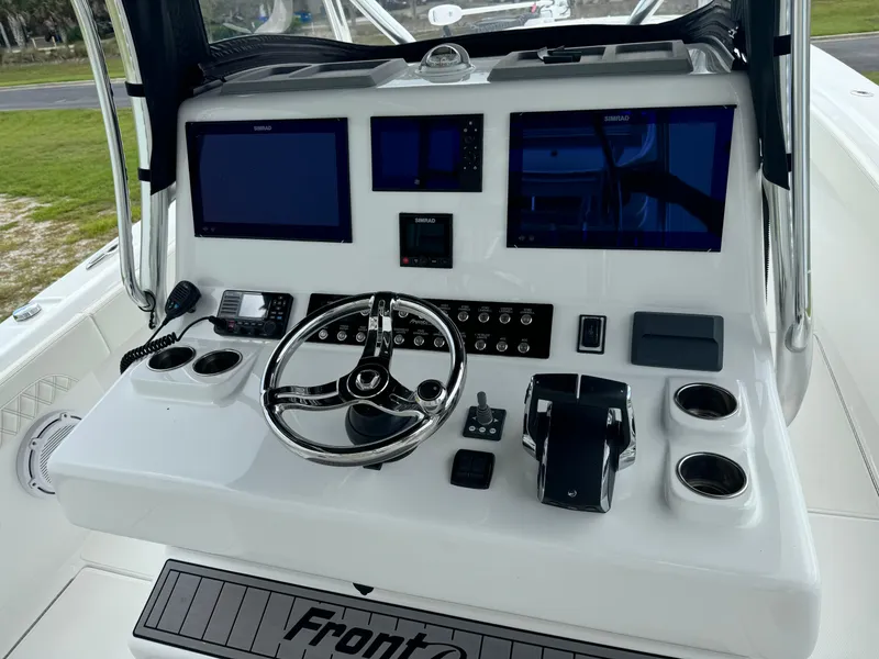Slide: The Image of 2023 Front Runner 36 Center Console boat dashboard with steering wheel and electronic displays. - 14