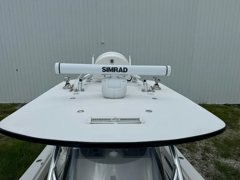 Slide: The Image of 2023 Front Runner 36 Center Console with Simrad radar, docked near a white building. - 17