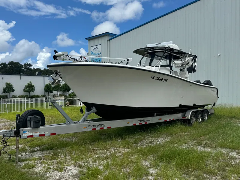 Slide: The Image of 2023 Front Runner 36 Center Console boat on trailer, parked outdoors. - 2