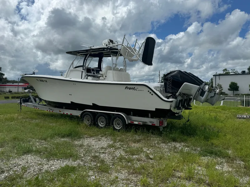 Slide: The Image of 2023 Front Runner 36 Center Console boat on trailer, parked on grassy area. - 3
