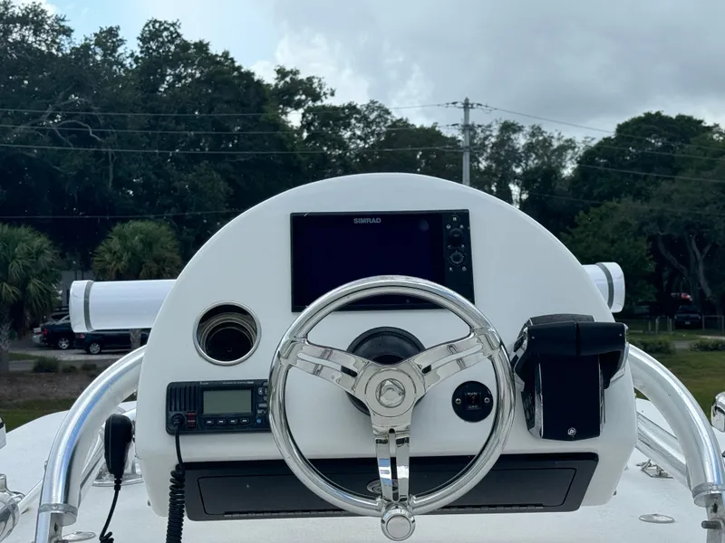 Slide: The Image of 2023 Front Runner 36 Center Console helm with steering wheel and navigation equipment. - 32