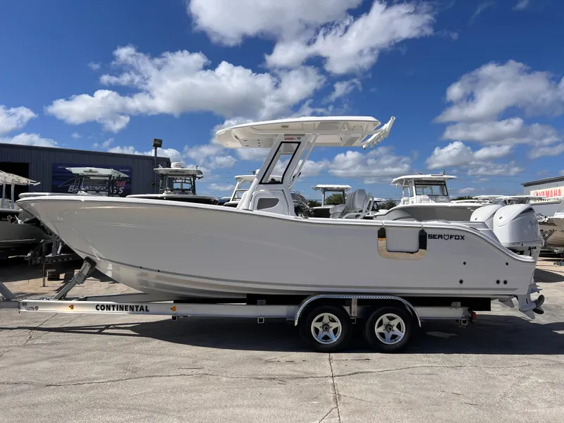 Slide: The Image of 2025 Sea Fox 268 Commander boat on trailer under blue sky. - 1