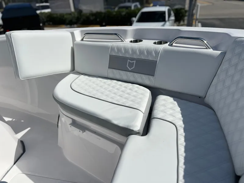 Slide: The Image of 2025 Sea Fox 268 Commander boat interior with white cushioned seating and cup holders. - 19
