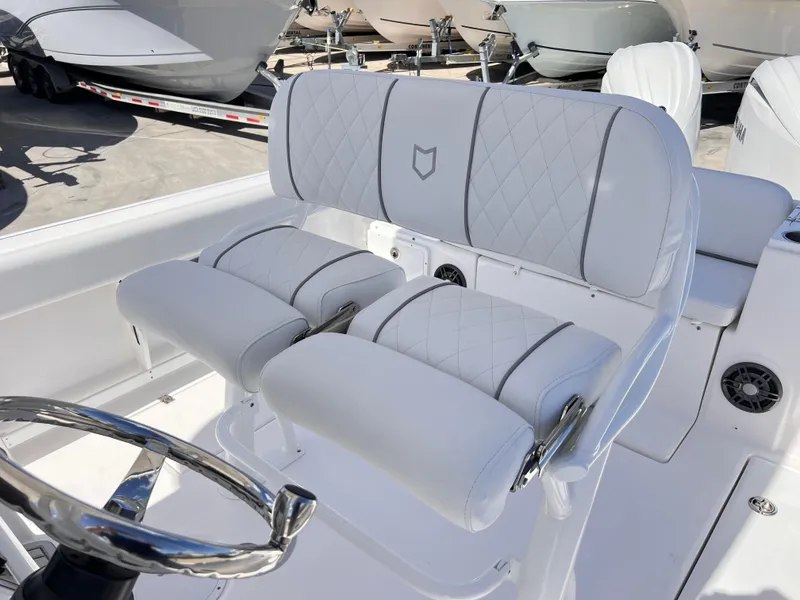 Slide: The Image of 2025 Sea Fox 268 Commander boat interior with white cushioned seating and steering wheel. - 22