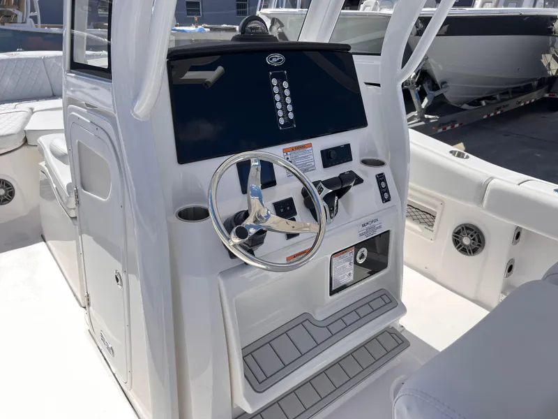 Slide: The Image of 2025 Sea Fox 268 Commander boat console with steering wheel and controls. - 24