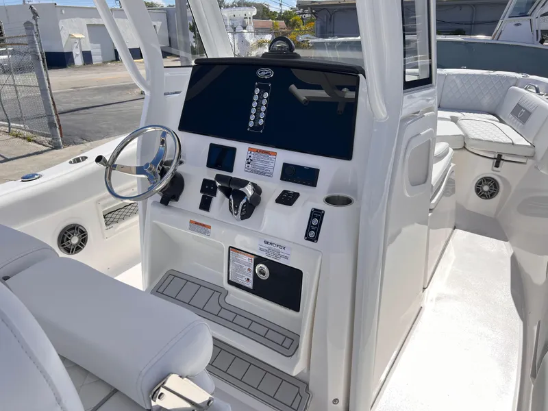 Slide: The Image of 2025 Sea Fox 268 Commander boat dashboard with steering wheel and controls. - 26