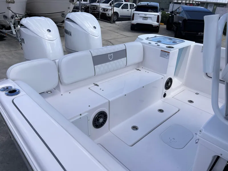 Slide: The Image of 2025 Sea Fox 268 Commander boat interior with seating and Yamaha engines in a parking area. - 31