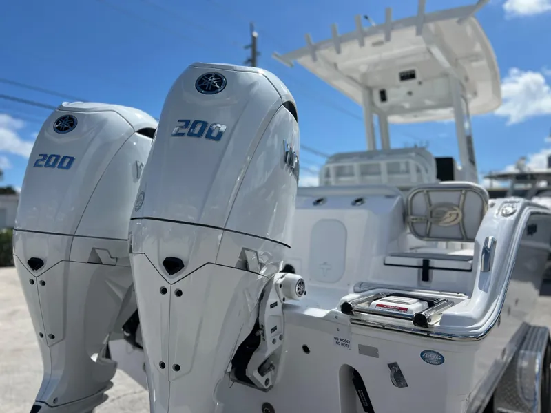 Slide: The Image of 2025 Sea Fox 268 Commander boat with dual 200 horsepower engines, under a clear blue sky. - 5