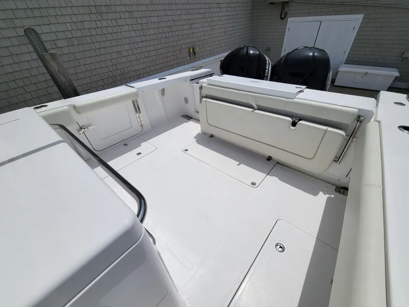 Slide: The Image of 2020 Southport 33 FE boat deck with seating and dual engines. - 16