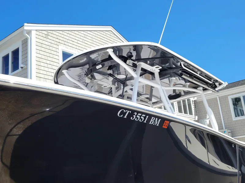 Slide: The Image of 2020 Southport 33 FE boat with registration CT 3551 BM, docked near a house. - 8