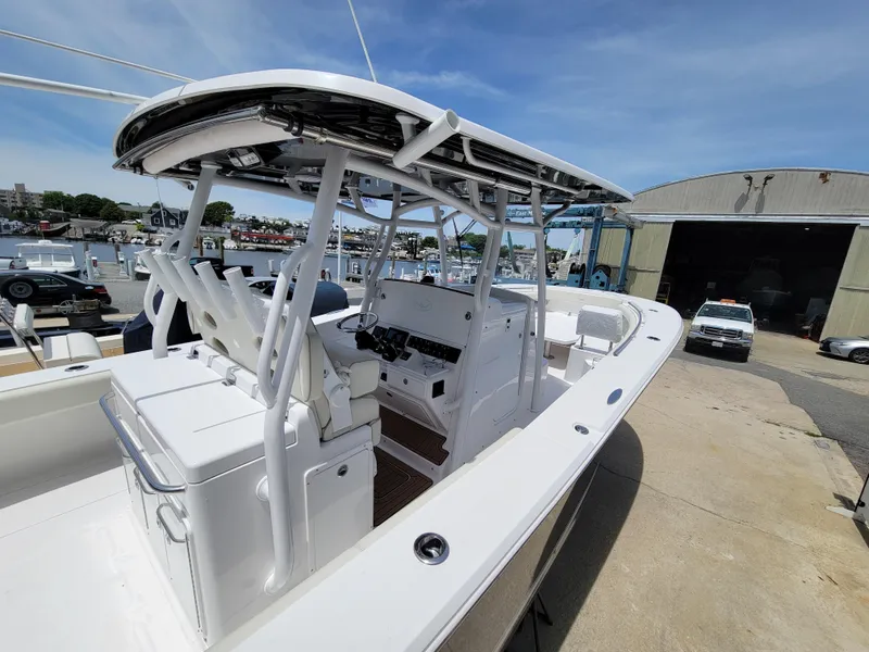 Slide: The Image of 2020 Southport 33 FE boat at a marina, featuring a spacious deck and modern design. - 9