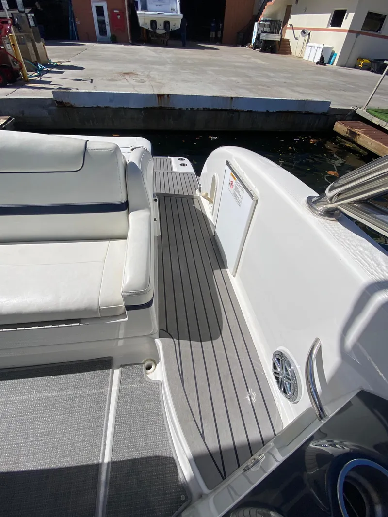 Slide: The Image of 2016 Formula 350 Crossover Bowrider, docked, featuring spacious seating and sleek design. - 10