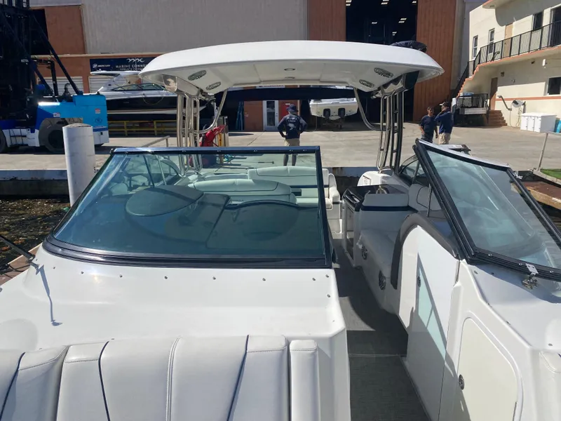 Slide: The Image of 2016 Formula 350 Crossover Bowrider at dock, featuring spacious seating and sleek design. - 12