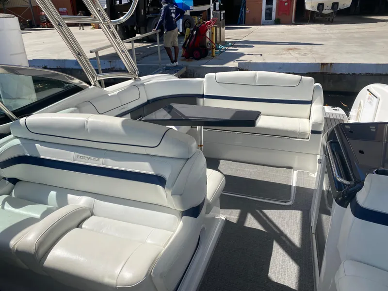 Slide: The Image of 2016 Formula 350 Crossover Bowrider with spacious seating and sleek design at the dock. - 13