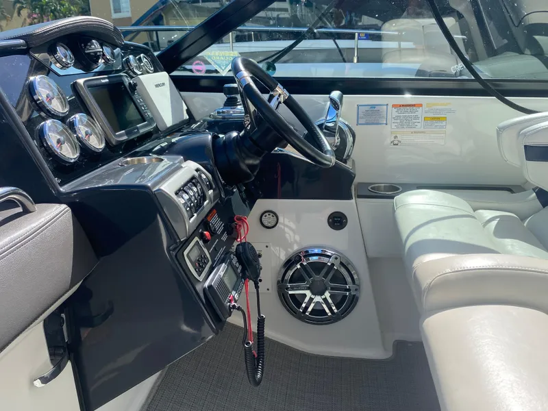 Slide: The Image of Interior view of 2016 Formula 350 Crossover Bowrider boat cockpit with steering wheel and controls. - 15