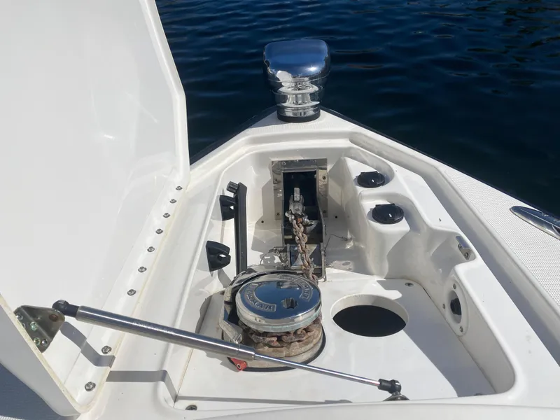 Slide: The Image of 2016 Formula 350 Crossover Bowrider anchor compartment with open hatch, docked on water. - 16