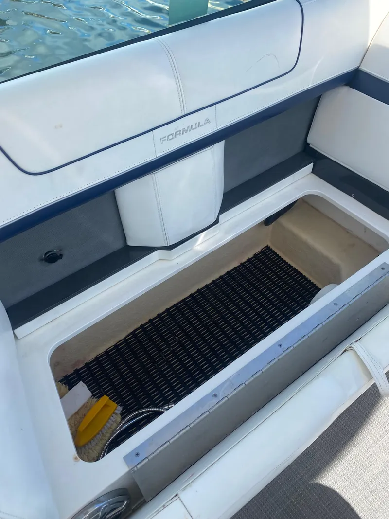 Slide: The Image of 2016 Formula 350 Crossover Bowrider storage compartment with open hatch, showcasing interior space. - 18