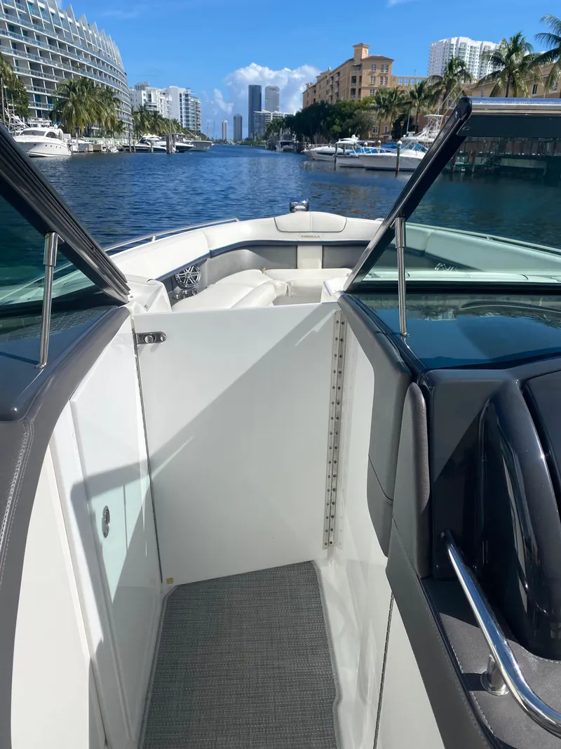 Slide: The Image of 2016 Formula 350 Crossover Bowrider on a scenic waterway with city skyline. - 19