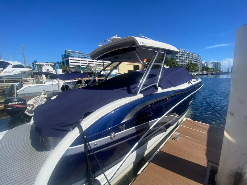 Slide: The Image of 2016 Formula 350 Crossover Bowrider docked at marina under clear blue sky. - 2