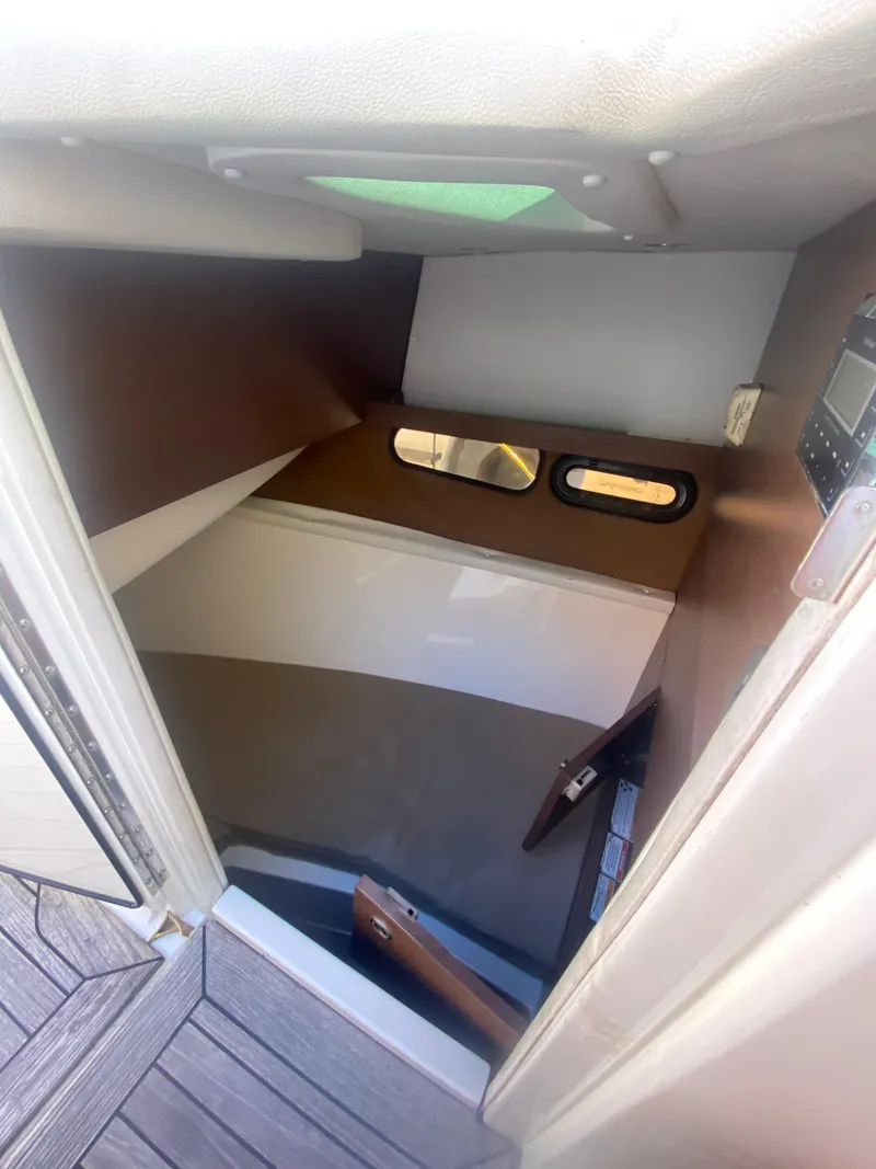 Slide: The Image of 2016 Formula 350 Crossover Bowrider cabin interior with wood accents and porthole window. - 22