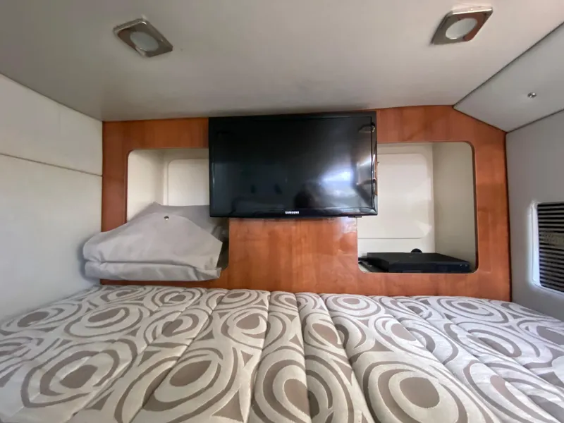 Slide: The Image of Interior cabin of 2016 Formula 350 Crossover Bowrider with TV and patterned bedding. - 27