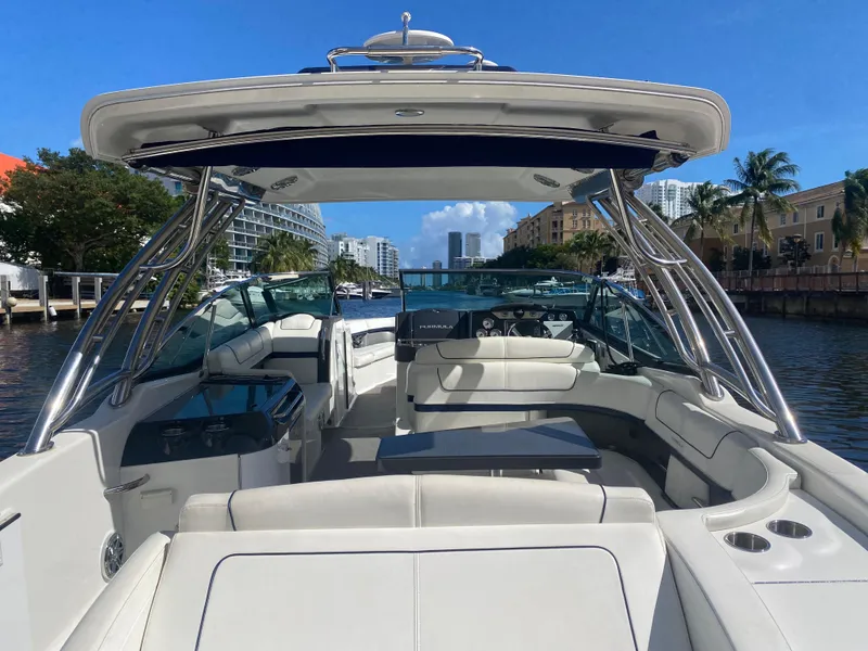 Slide: The Image of 2016 Formula 350 Crossover Bowrider on a sunny waterway, showcasing spacious seating and sleek design. - 5