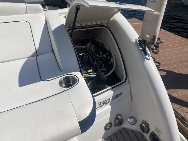 Slide: The Image of 2016 Formula 350 Crossover Bowrider storage compartment with ropes on a dock. - 8