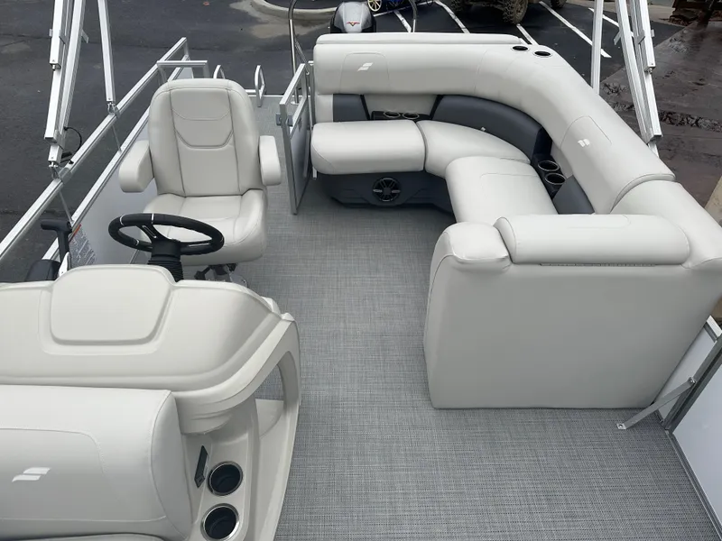Slide: The Image of 2024 Starcraft LX 20 CB boat interior with gray seating and steering console. - 10