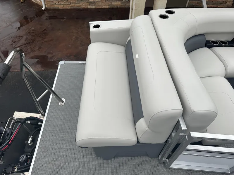 Slide: The Image of 2024 Starcraft LX 20 CB boat interior with gray seating and cup holders. - 12