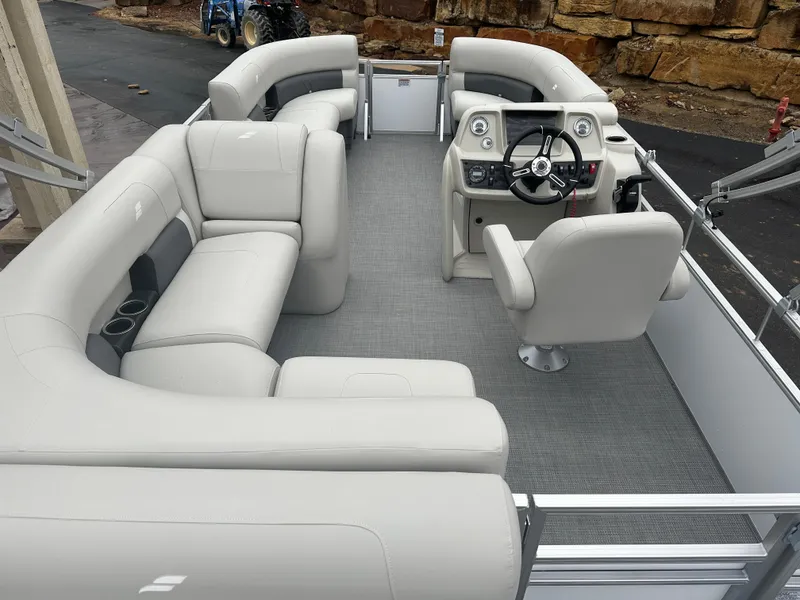 Slide: The Image of 2024 Starcraft LX 20 CB pontoon boat interior with plush seating and modern helm. - 14