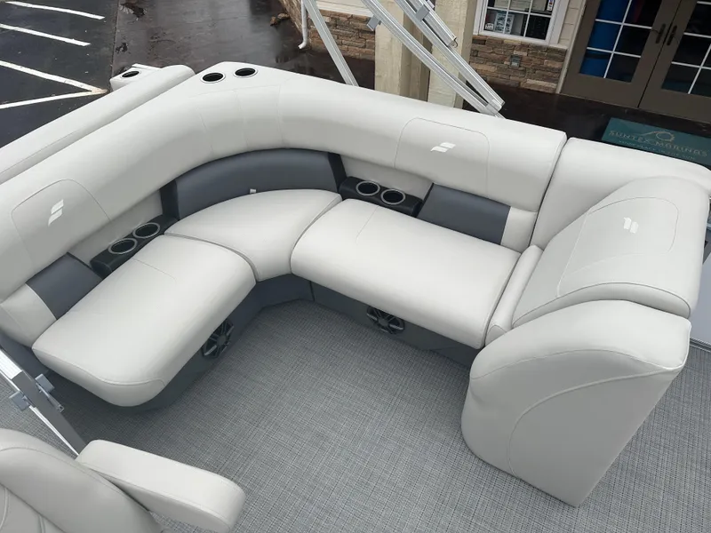 Slide: The Image of 2024 Starcraft LX 20 CB boat interior with plush seating and cup holders. - 15