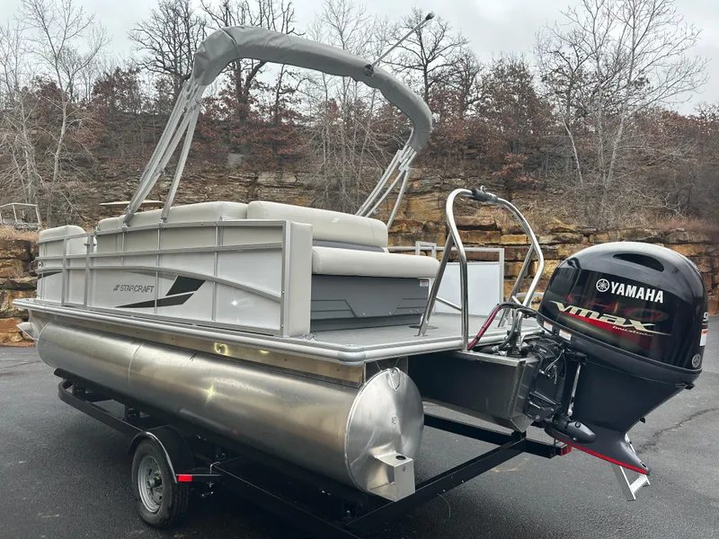 Slide: The Image of 2024 Starcraft LX 20 CB pontoon boat with Yamaha VMAX engine on trailer. - 2