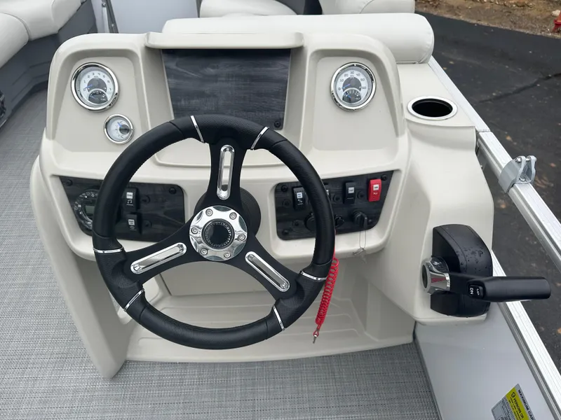 Slide: The Image of 2024 Starcraft LX 20 CB boat dashboard with steering wheel and controls. - 7