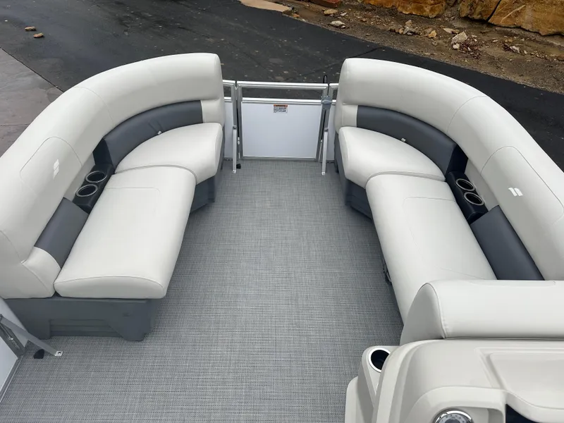 Slide: The Image of 2024 Starcraft LX 20 CB boat interior with gray and white seating and cup holders. - 8