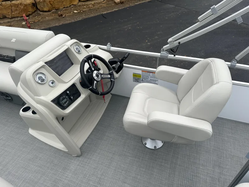Slide: The Image of 2024 Starcraft LX 20 CB boat interior with steering wheel and captain's chair. - 9