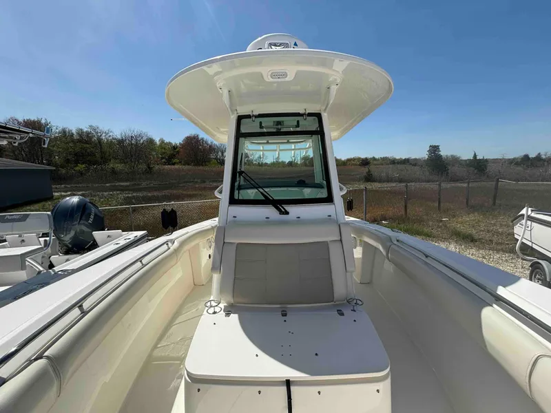 Slide: The Image of 2021 Boston Whaler 250 Outrage boat, center console, white interior, outdoor setting. - 10